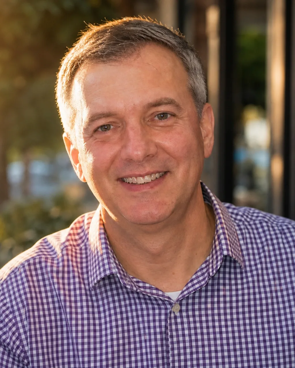 The same man as a solo portrait in warm light with the strangers and party lighting removed