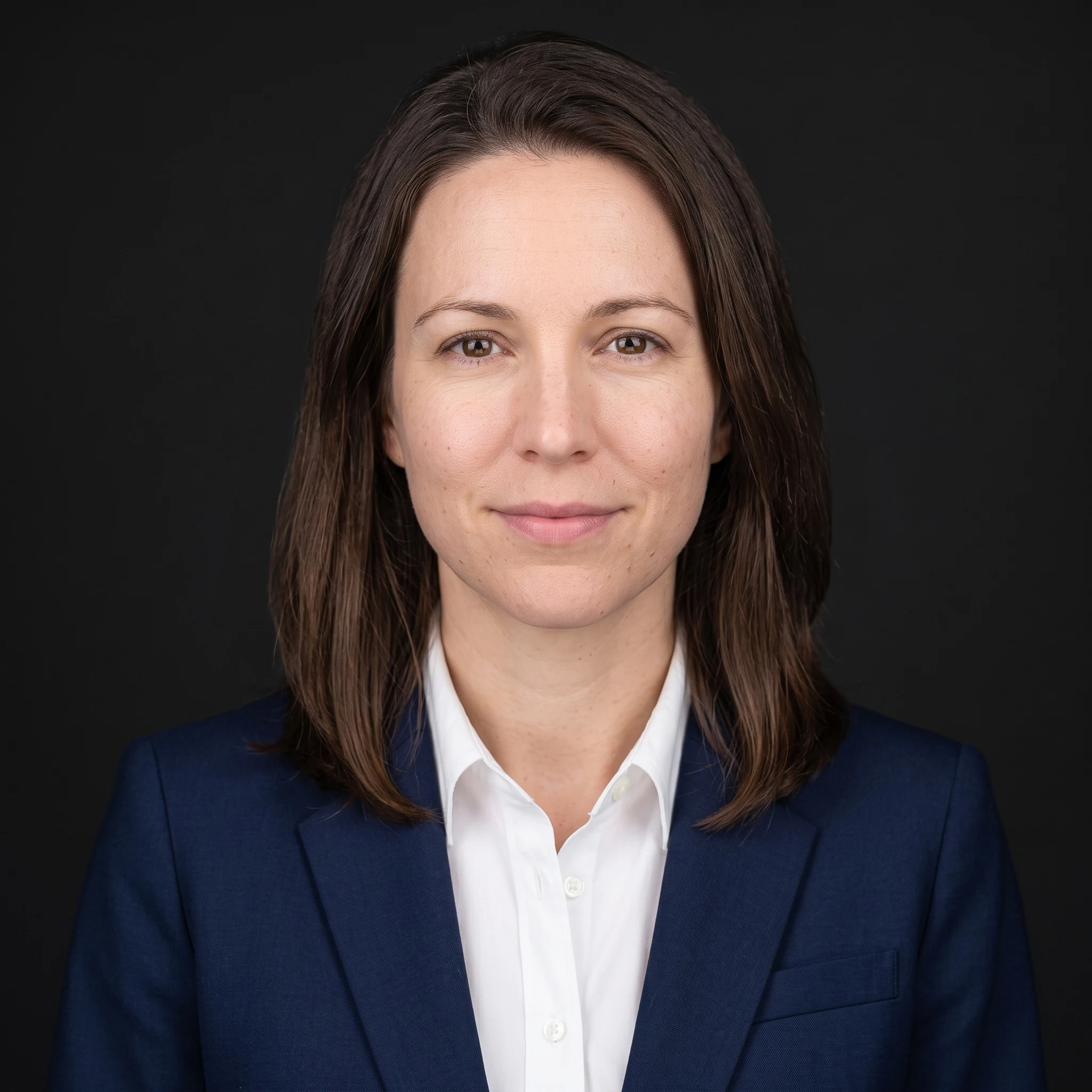 AI headshot in a navy suit and white shirt on a near-black studio background