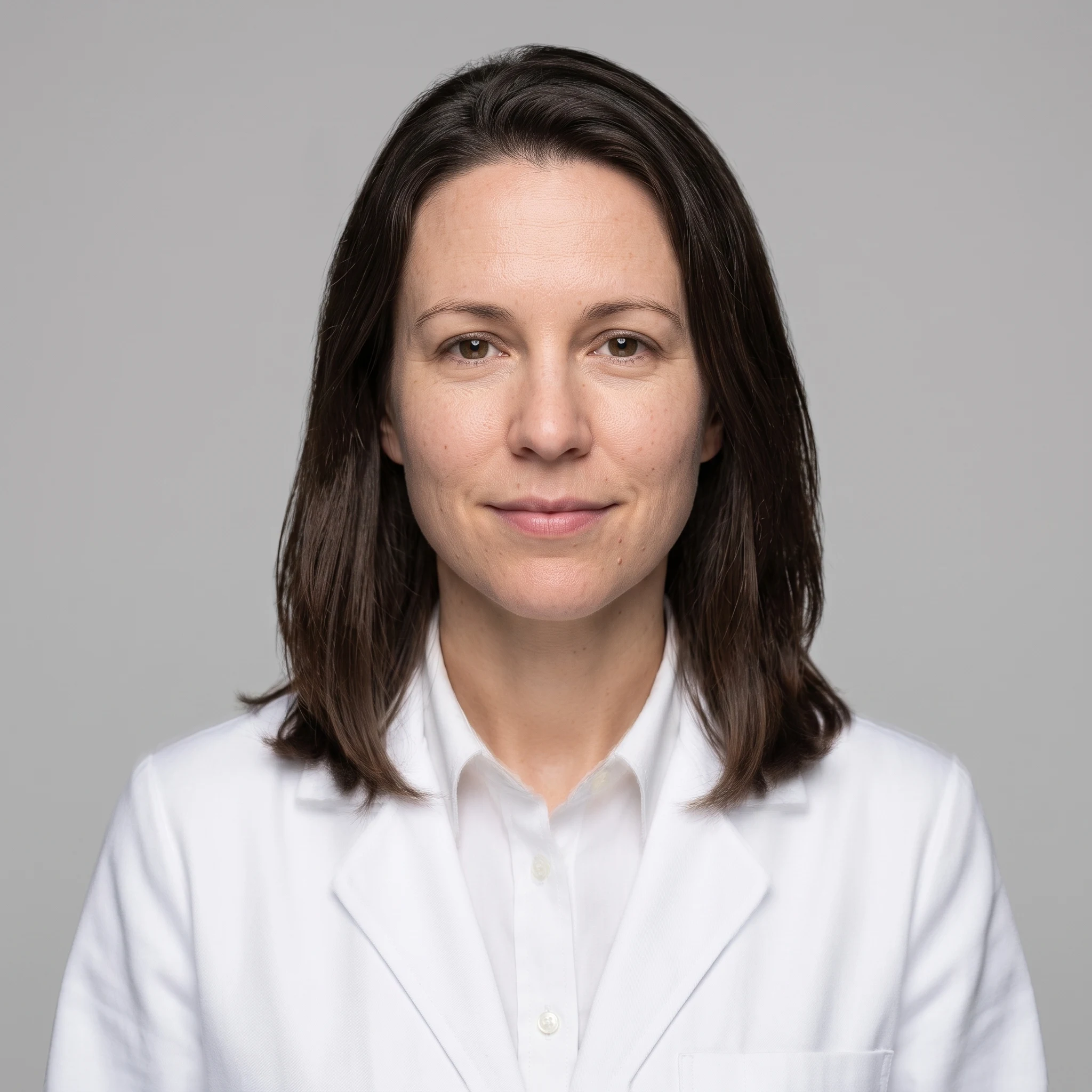 AI headshot in a white medical coat over a collared shirt on a light grey studio background